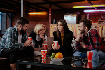 Multi ethnic group of office worker while have a lunch time they have a conversation with their colleagues drinking some coffee and feeling fresh