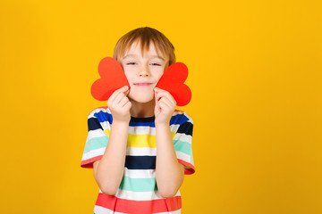 Cute little boy with Valentine greeting cards. People, lifestyle and holidays