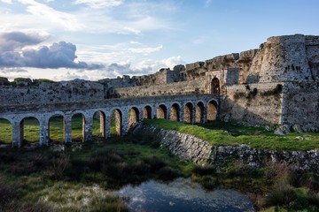 Methoni Castle with a viaduct bridge in sunny weather during early morning hours with shadows