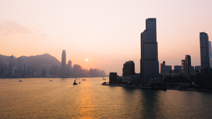 Fototapeta na wymiar Aerial scenery panoramic view of Hong Kong Evening with metropolitan bay Victoria Harbor at sunset. Lighted Modern cityscape, urban skyline buildings. Energy power infrastructure. Popular Asian city