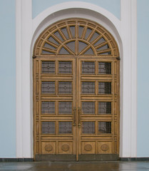Wooden doors of a modern temple with glazing.