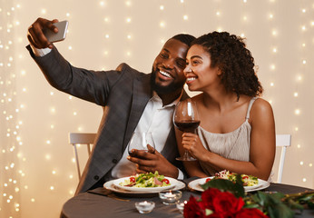 Beautiful romantic black couple posing for selfie