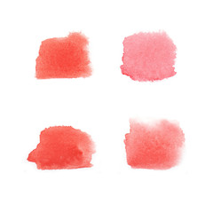 Set of blurry watercolour stains isolated on a white background. Hand drawn watery brush strokes in shades of red colour.