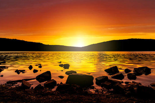 The Orange Glow Of The Sunset As It Sets Over Devil's Lake In Baraboo, Wisconsin, USA.