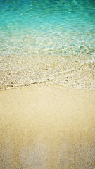 Fototapeta na wymiar Beautiful sand and soft blue wave of the sea. Summer beach background.