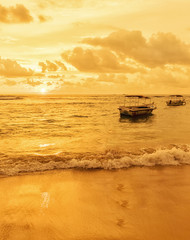 Fishing boats against the backdrop of a golden sunset off the coast of Sri Lanka