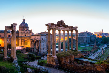 Fototapeta na wymiar Roman ruins in Rome, Forum. Ancient ruins of the Romanum Forum. Ruins of Septimius Severus Arch and Saturn Temple, Rome, Italy.