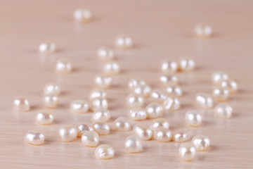 The white river pearls are scattered on the table. Jewelry.