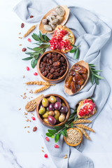 Fototapeta na wymiar Tu Bishvat holiday symbols - dried fruits, pomegranate, barley, wheat