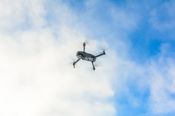 A quadcopter with a built-in camera flies into the sky, captures video footage of the photo.