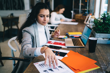 Busy remote worker reviewing report at workplace
