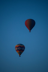 Cappadocia, Turkey, Europe: hot air balloons floating at dawn and view of the valley around Cavusin, town of the historical region in Central Anatolia rich of exceptional natural wonders