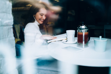 Cheerful lady enjoying reading book