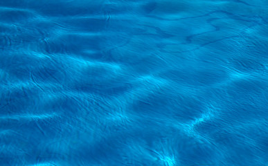 Fototapeta na wymiar Abstract sea water texture background.Blue swimming pool surface.Selective focus.