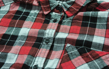 Plaid shirt with tartan check pattern. Flannel red, black, grey and white shirt, close up view of...