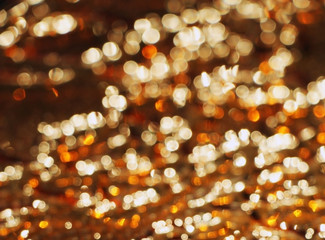 Colored glass. Gold and brown background. The texture of the glass. Yellow patterns. Design.