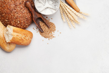 Various bread with wheat, flour and cooking utensils