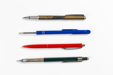 Collection of multi-colored ballpoint pens isolated on a white background