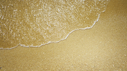 Soft wave of the sea on sand. Summer nature background.