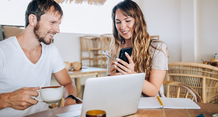 Young female worker offering colleague ideas on project