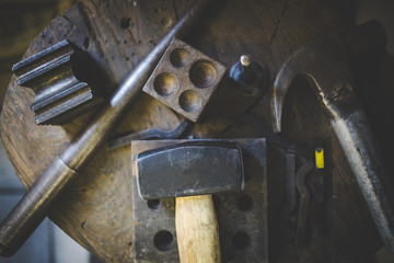 Close up image of a jeweler making jewelery with traditional hand tools in a jewelery shop.