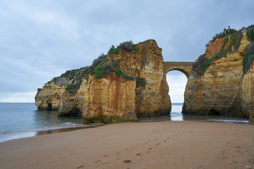 Praia dos estudantes beach with arch bridge in Lagos, Portugal