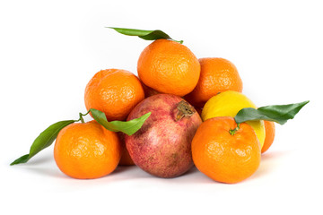 Fruits that are useful to eat all year long - tangerines, pomegranate, lemon on a white background