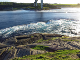 Mighty whirlpools of the strongest tidal current of the world: Saltstraumen in a beautiful rock...