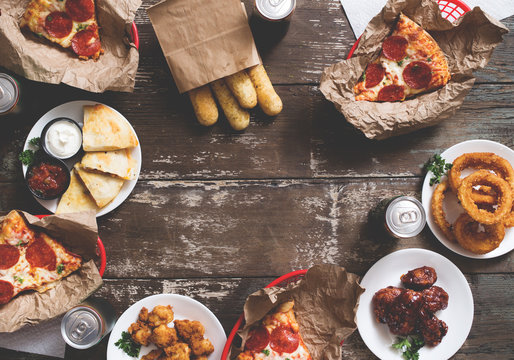 American Appetizer Party Spread With Pizza, Onion Rings, Wings, And Quesadillas