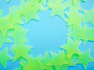 blue background with yellow-green stars laid out in the shape of a circle, free space for your text.