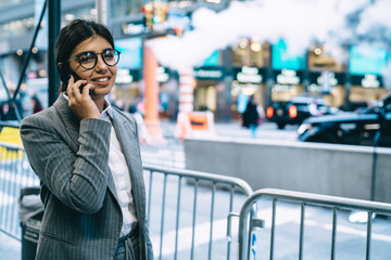 Happy and positive businesswoman during phone conversation