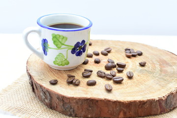  Traditional Colombian coffee cup and coffee beans on wooden background