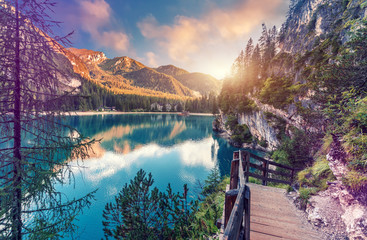 Wonderful sunrise view of Braies lake. Dramatic Unusual Scene. Colorful Sky over lago di Braies in Dolomites Alps. Awesome Alpine Highlands during sunset. Amazing nature Landscape at Summer Day