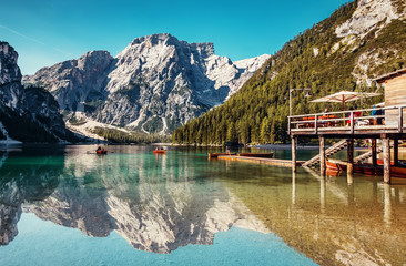 Sunny morning at Famouse Mountain Lake in dolomites Alps. Wonderful Braies Lake during sunrise. Amazing Summer Mountain Landscape. Lago di Braies in Spring, Awesome nature Scenery. Pragser wildsee