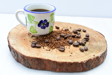  Traditional Colombian coffee cup and coffee beans on wooden background