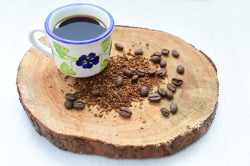  Traditional Colombian coffee cup and coffee beans on wooden background