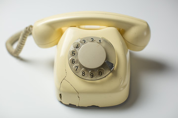 Retro rotary telephone with cracks and broken parts