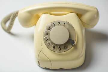 Retro rotary telephone with cracks and broken parts