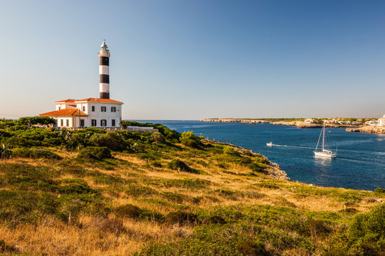 Portocolom lighthouse with boat below, Mallorca