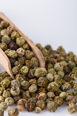 spicy green peppers on white acrylic background