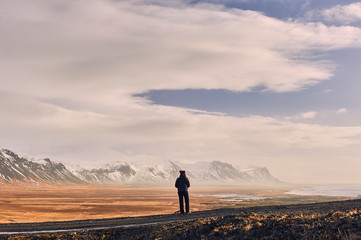 woman contemplating the loneliness of the Icelandic landscape. Snaefellnes peninsula, region of...