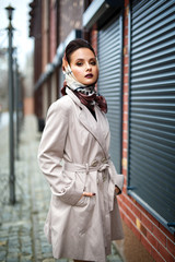 Beautiful woman portrait in a coat urban style