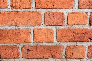Grunge red brick wall with textured blocks, selective focus. Old stone wall. Red bricks background....