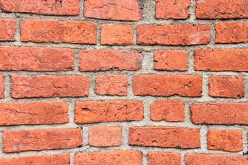 Grunge red brick wall with textured blocks, selective focus. Old stone wall. Red bricks background. Construction works.  Brickwork. 