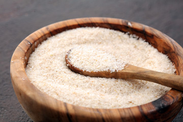 Portion of Psyllium Seeds on rustic dark background. Psyllium seed husks on wood