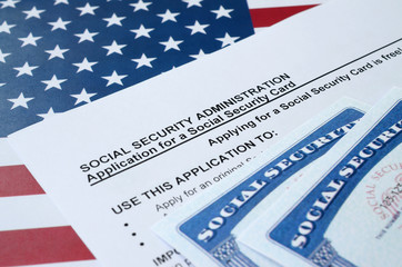 United States social security number cards lies on Application from social security administration...