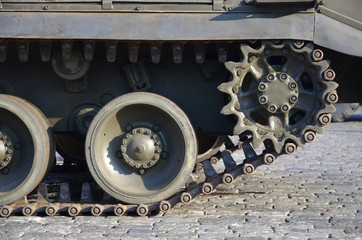 Close up of green armoured caterpillar transport. Modern military transportation vehicle...