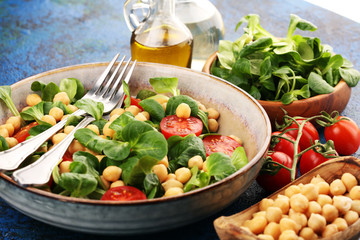chickpea salad with ingredient and tomatoes and lamb´s lettuce. healthy salad