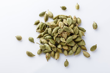 fragrant green cardamom on a white acrylic background