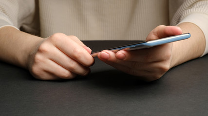 Close-up of a woman using mobile smart phone. Smartphone in female hands